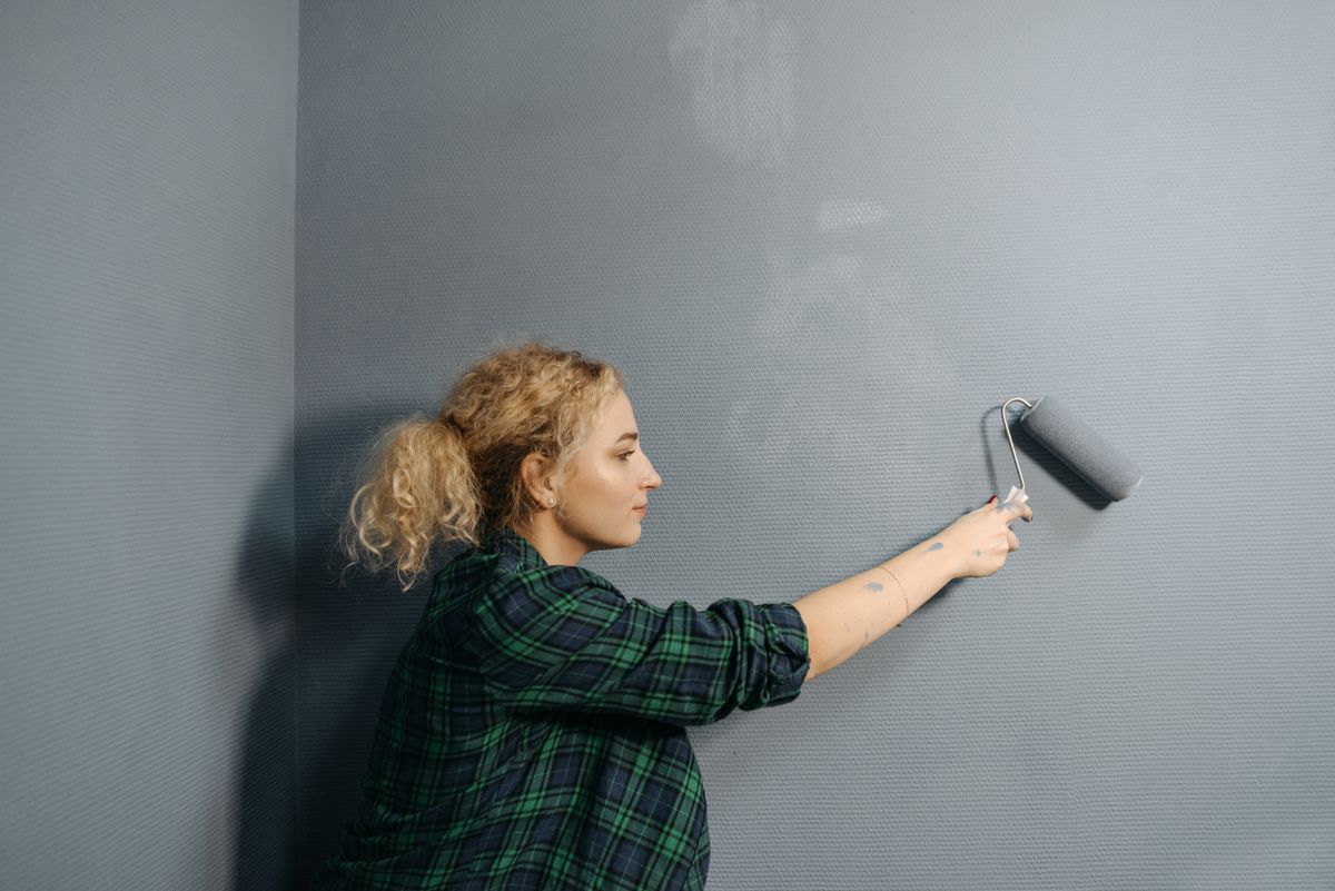 Painter preparing a wall during a unit turn